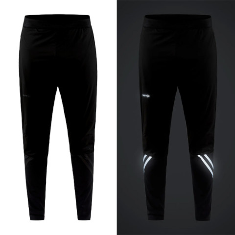 Zwarte trainingsbroek met reflectoren erop voor zichtbaarheid van het merk Craft voor te hardlopen